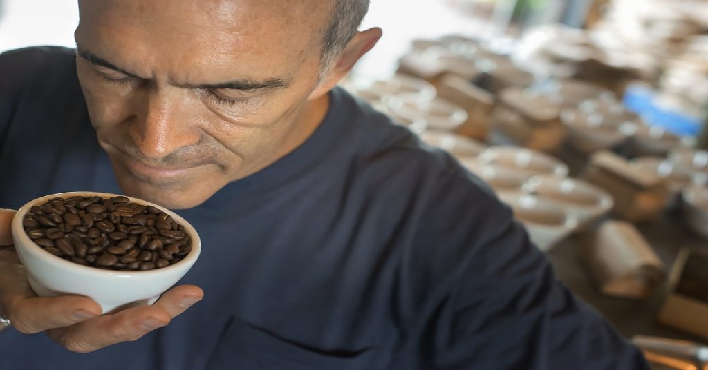 The sampling procedure in a coffee processing shed, where staff make coffee in small pots and sample the taste to test the blend.